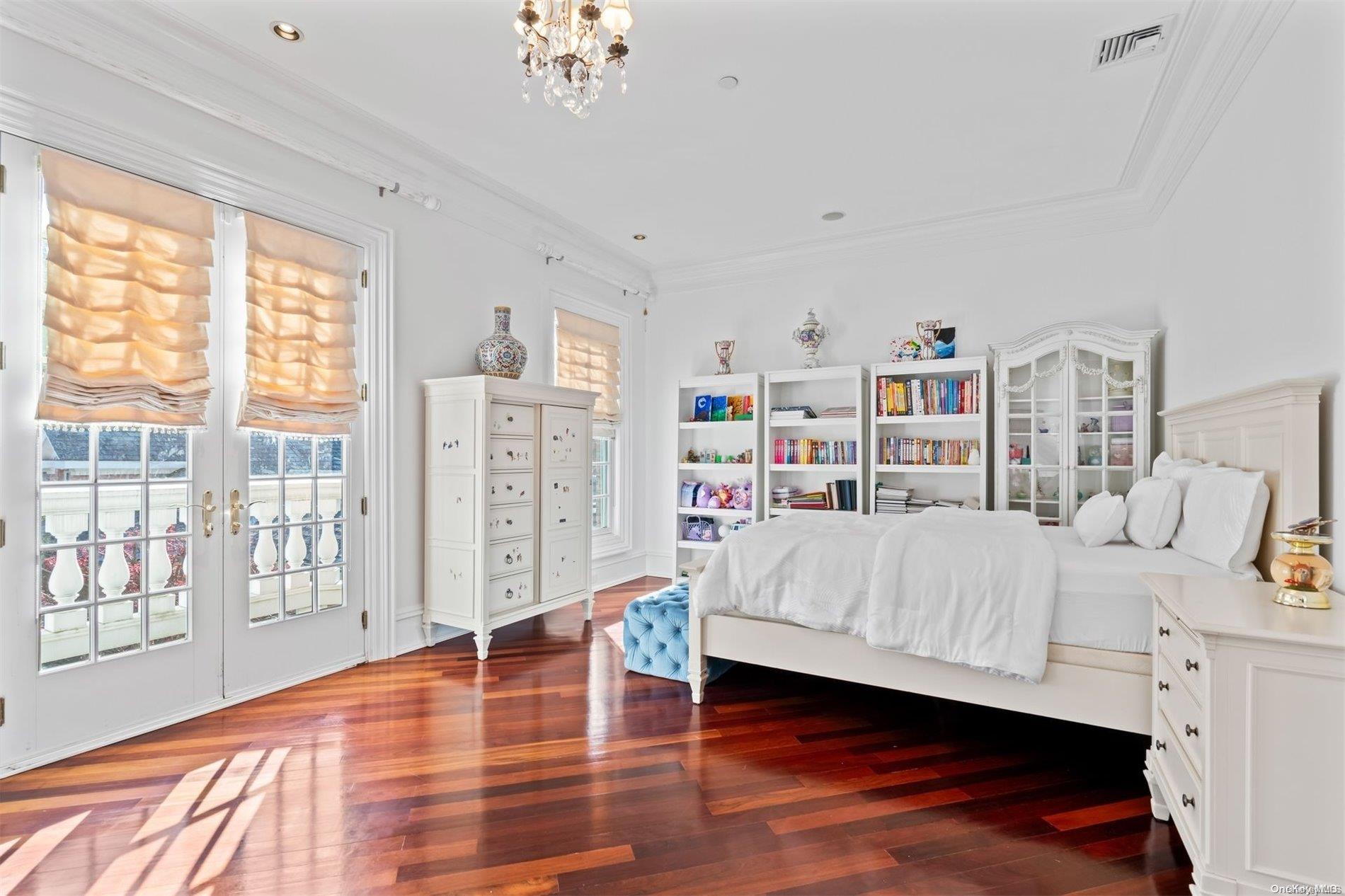 660 Chicken Valley Road Locust Valley, NY 11560 - Photo 20 of 50 a bedroom with furniture and a book shelf
