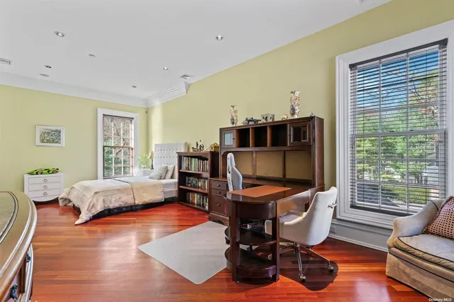 a bedroom with furniture and a large window