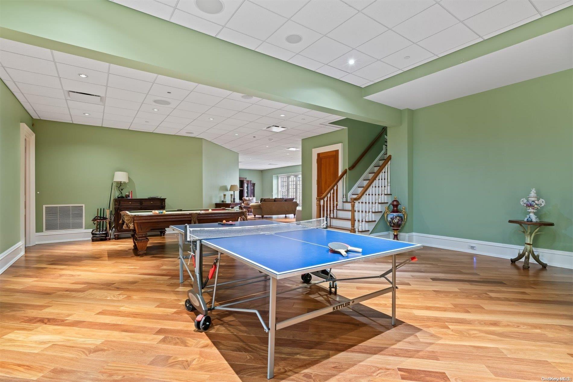 660 Chicken Valley Road Locust Valley, NY 11560 - Photo 23 of 50 a room with table tennis table and windows