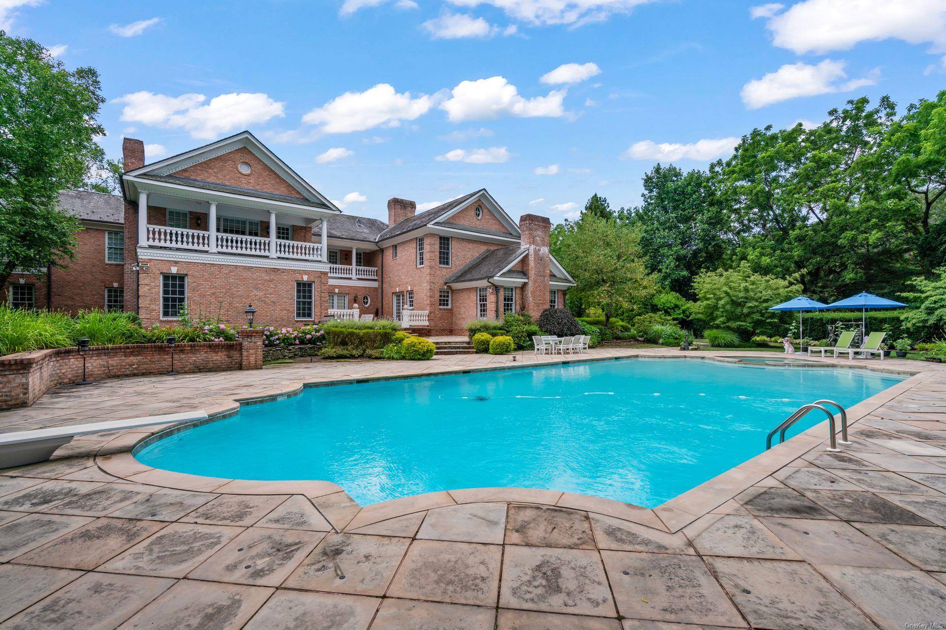 660 Chicken Valley Road Locust Valley, NY 11560 - Photo 43 of 50 a view of a house with a swimming pool
