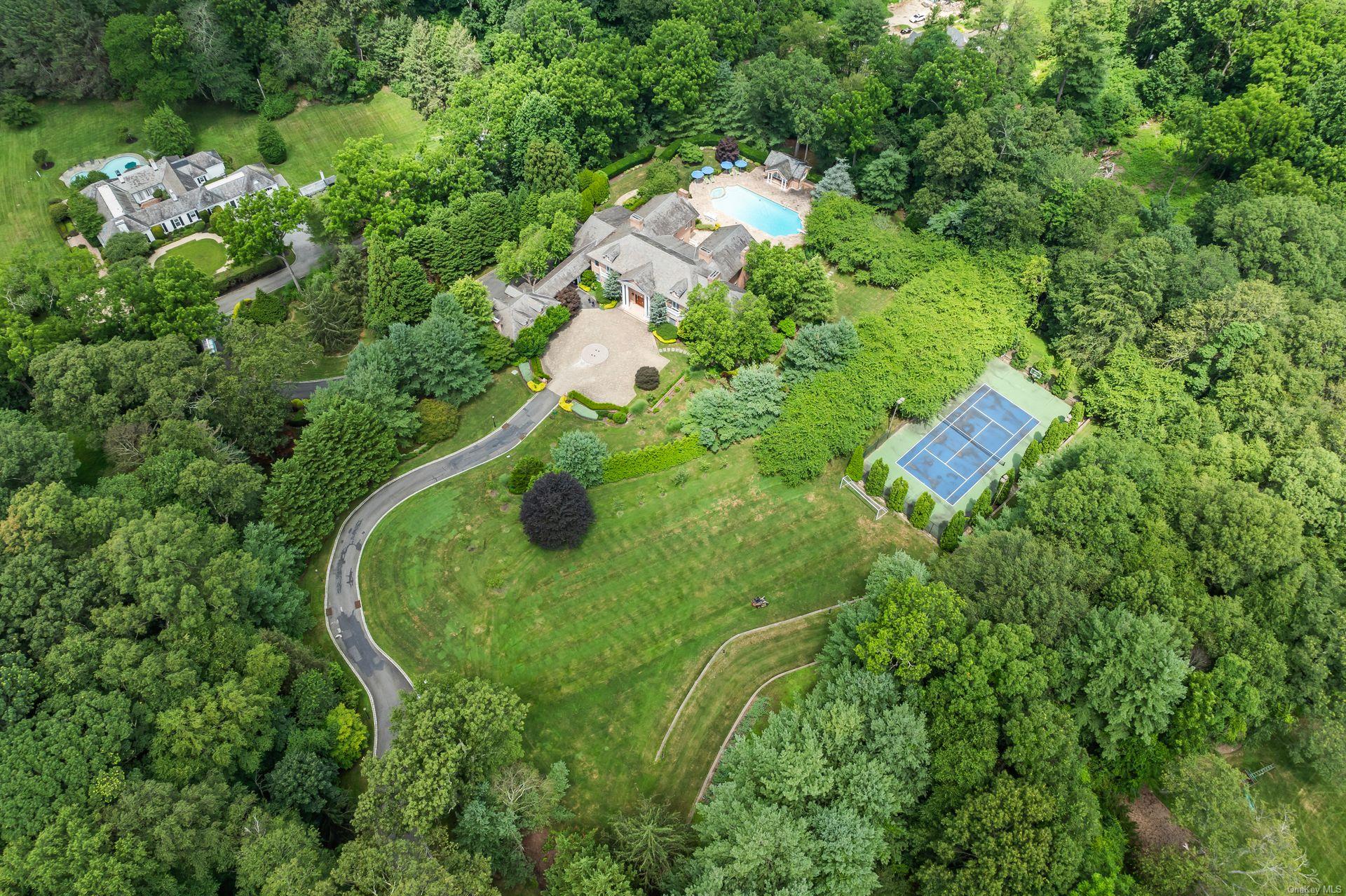 660 Chicken Valley Road Locust Valley, NY 11560 - Photo 50 of 50 an aerial view of a house with a yard and trees all around