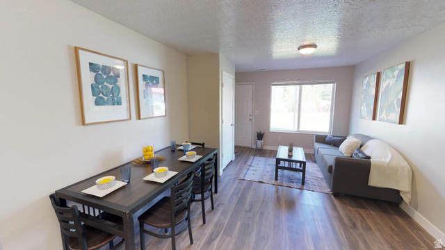 856 East 300 South Provo, UT 84606 - Photo 5 of 9 Dining area featuring a textured ceiling and dark wood-type flooring