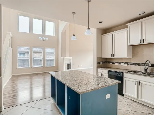 a kitchen with stainless steel appliances granite countertop a stove a sink dishwasher and a refrigerator