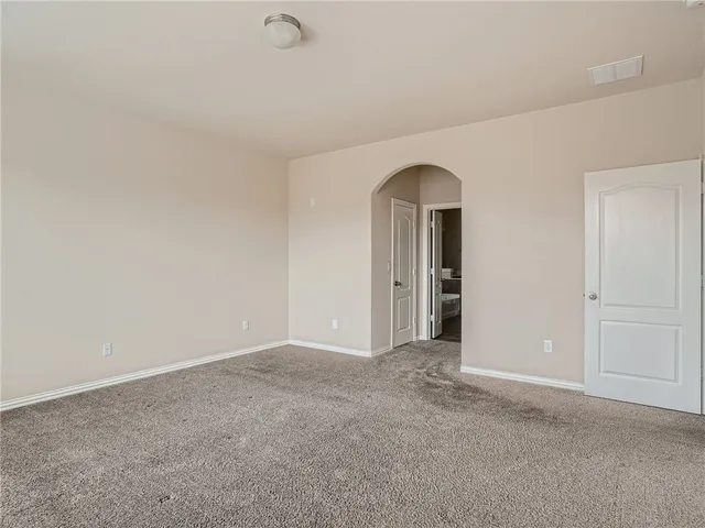 a view of an empty room with glass door
