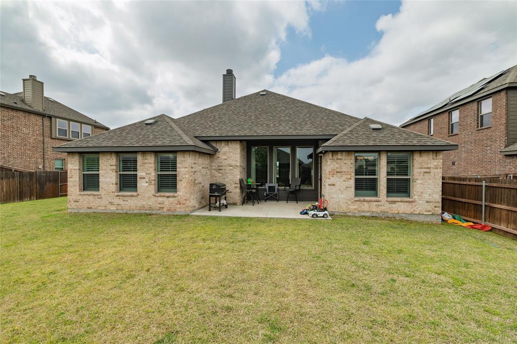 4045 Grove Valley Road Midlothian, TX 76065 - Photo 32 of 34 Back of property with a fenced backyard, brick siding, a shingled roof, a chimney, and a patio area