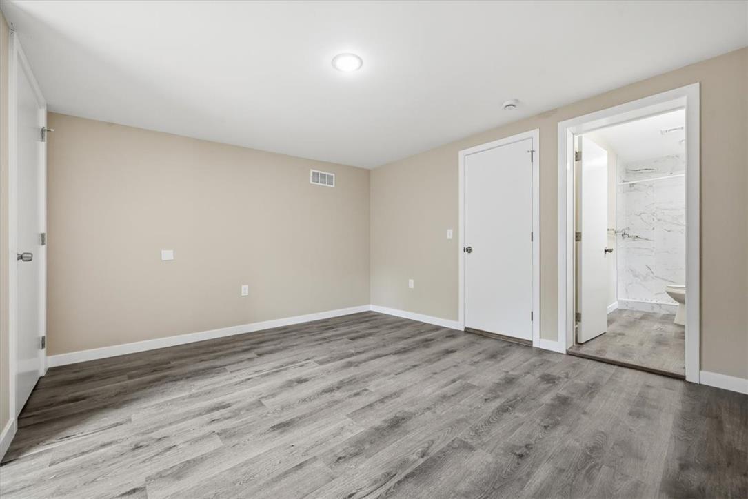 5641 North Coplay Road Whitehall, PA 18052 - Photo 27 of 68 Ample space for relaxation, this primary bedroom features durable flooring and direct bathroom access.