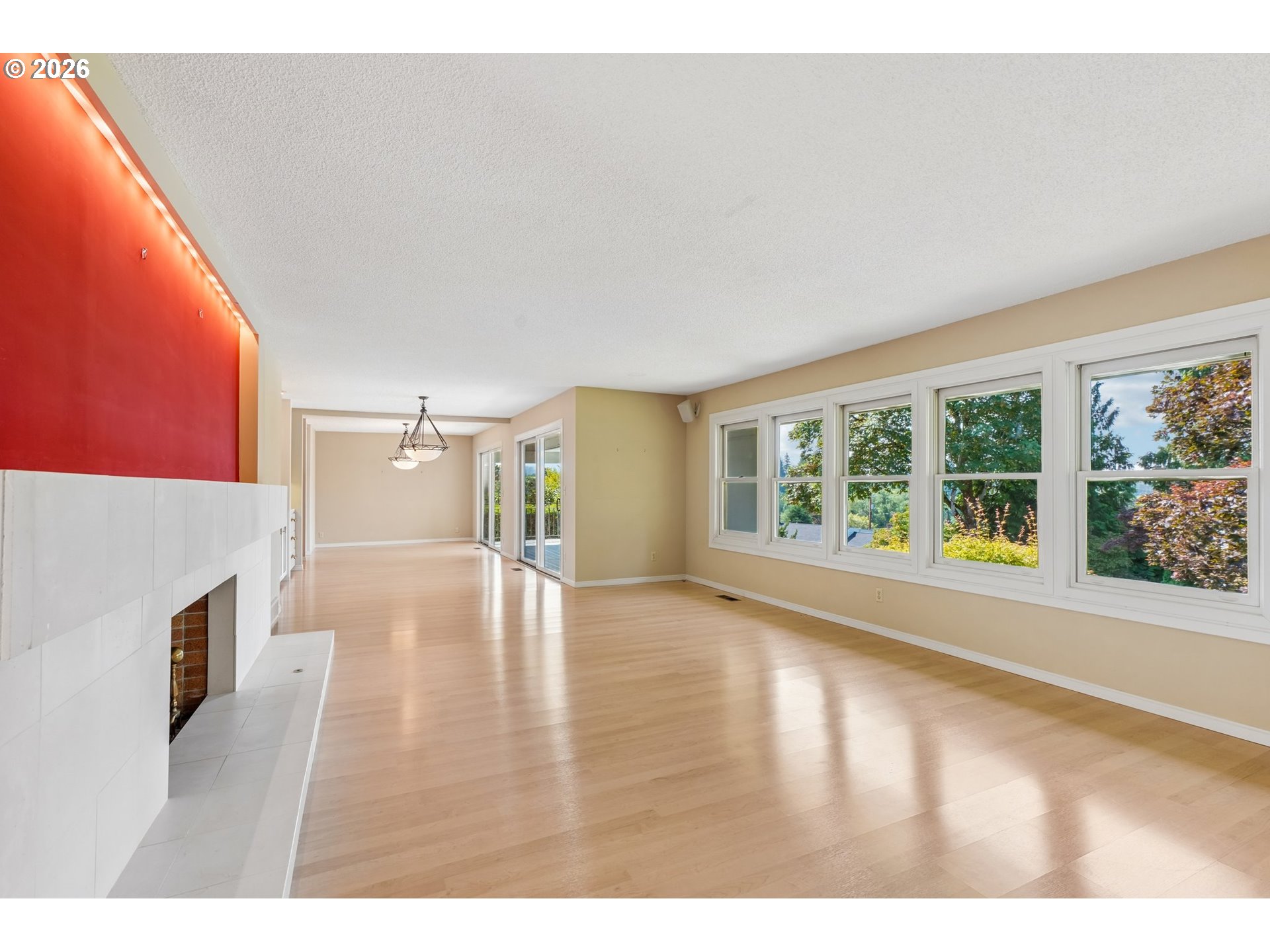 7600 Southwest Northvale Way Portland, OR 97225 - Photo 5 of 46 a view of a livingroom with wooden floor and a fireplace