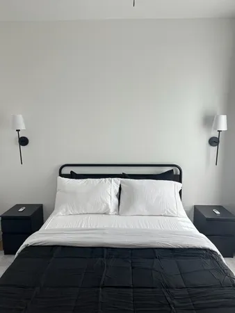 a bedroom with a bed and window