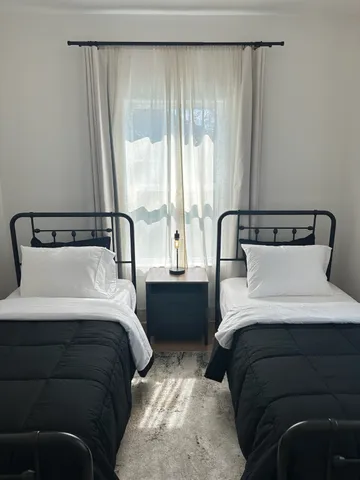 a view of a backyard with wooden fence