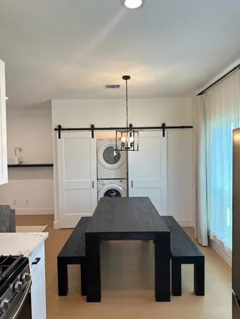 a kitchen view with a sink a refrigerator and a stove top oven