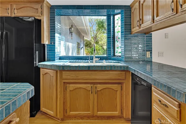a kitchen with stainless steel appliances granite countertop cabinets and window