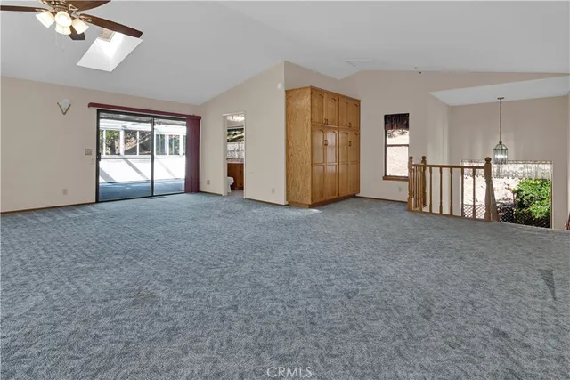 a view of empty room with a fireplace and window