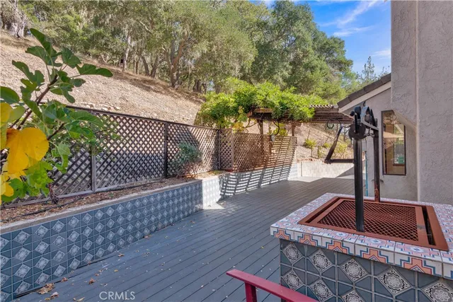 a view of roof deck with wooden floor and fence