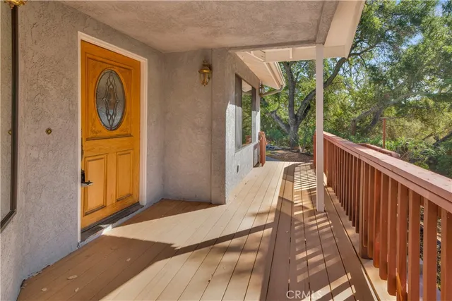 a view of a porch with wooden floor and outdoor space