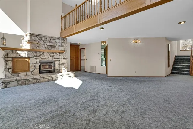 an empty room with fireplace and hall