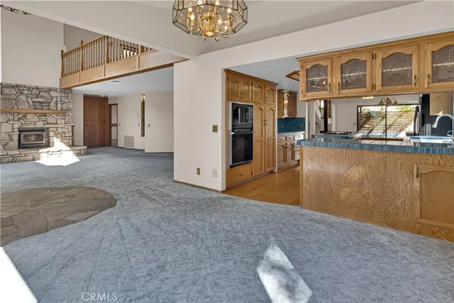 a view of a livingroom with furniture and a kitchen