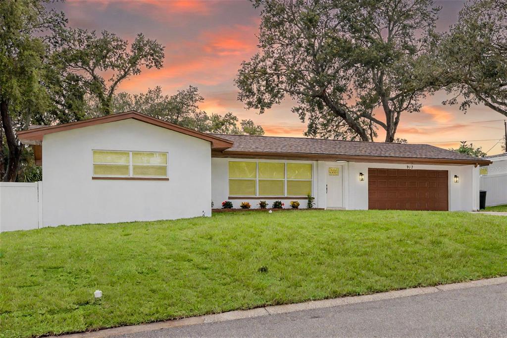 a view of a house with a yard and sitting area