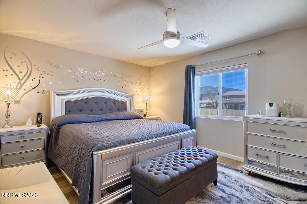 8957 Buffalo Grove Drive Reno, NV 89506 - Photo 18 of 59 a bedroom with a bed and a dresser