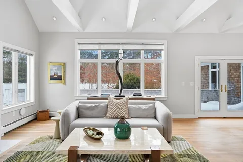 a living room with furniture fireplace and a flat screen tv