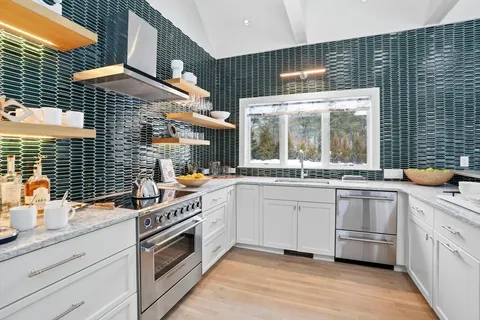 a kitchen with a sink stove and cabinets