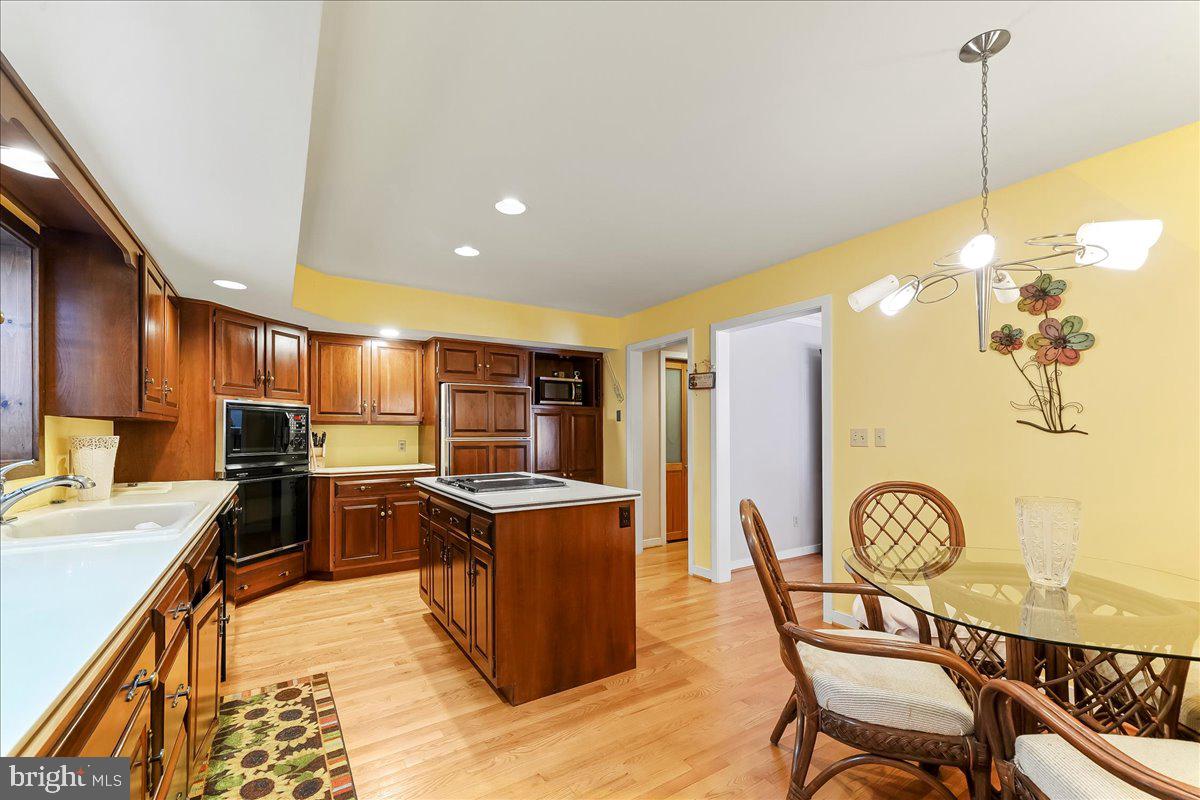 531 Chandler Mill Road Kennett Square, PA 19348 - Photo 21 of 60 a kitchen with stainless steel appliances a dining table chairs and white cabinets