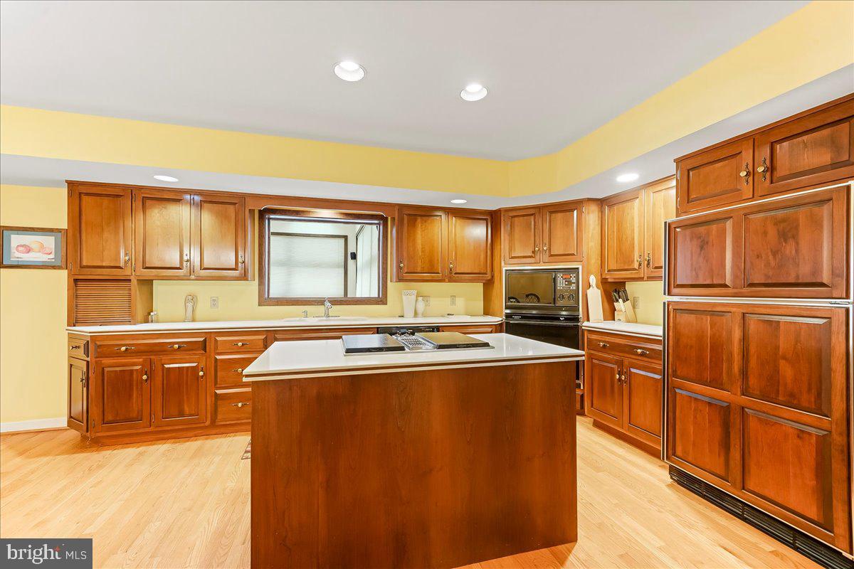 531 Chandler Mill Road Kennett Square, PA 19348 - Photo 22 of 60 a kitchen with stainless steel appliances granite countertop a refrigerator a sink dishwasher and wooden cabinets with wooden floor