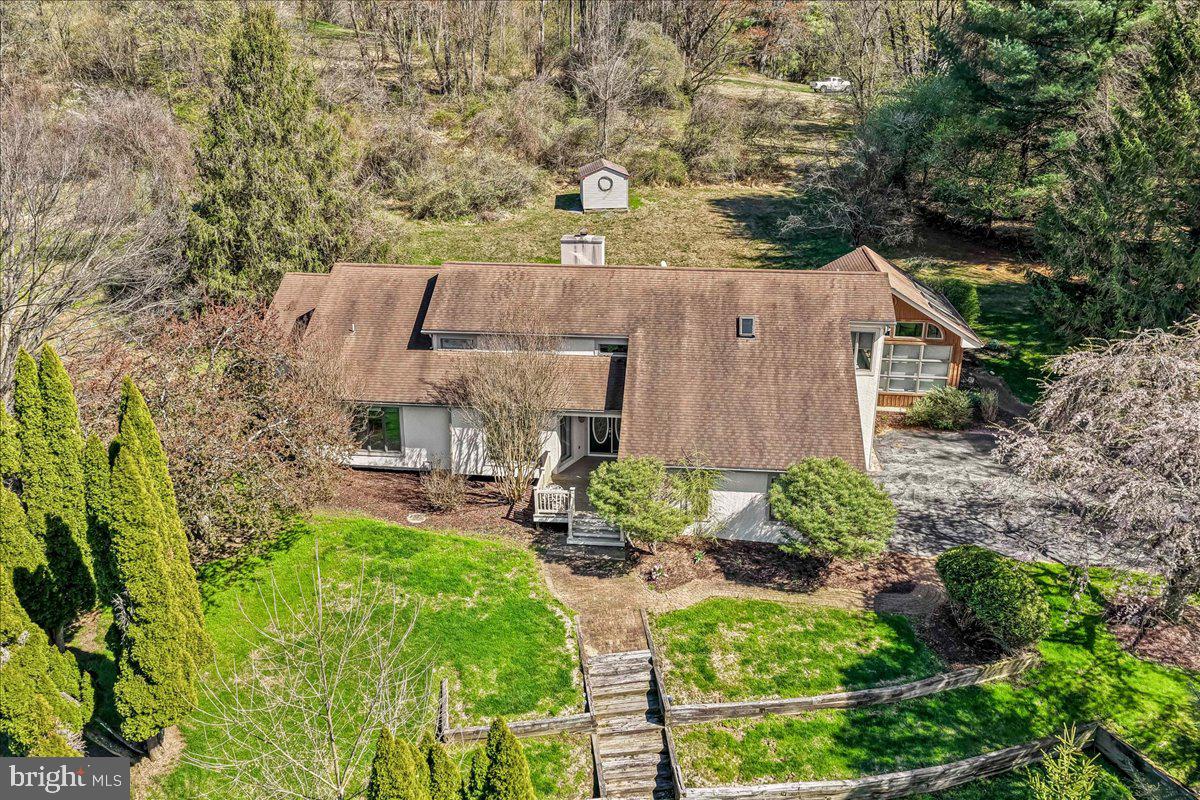 531 Chandler Mill Road Kennett Square, PA 19348 - Photo 58 of 60 a aerial view of a house with table and chairs under an umbrella