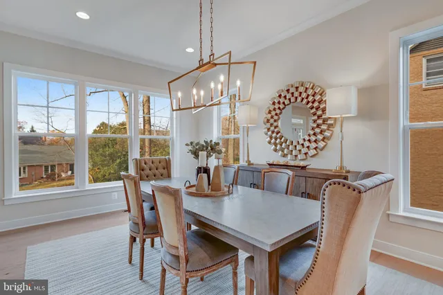 a large white kitchen with lots of counter space wooden floor and appliances