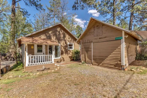 a view of a house with a small yard and wooden fence