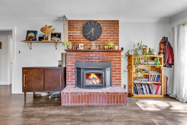 a living room with fireplace furniture and a wooden floor