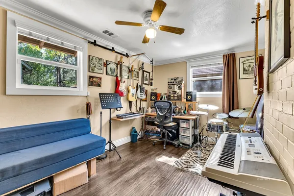 a living room with furniture fireplace and a window
