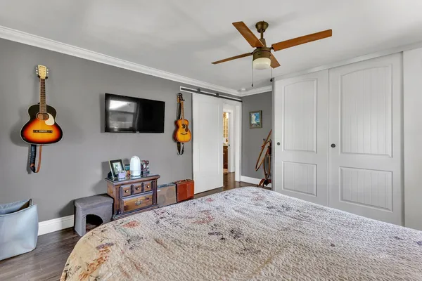 a bedroom with a bed and a chandelier