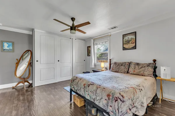 a bedroom with a bed and a chandelier