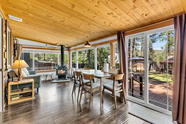a living room with furniture and a floor to ceiling window