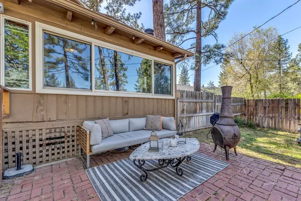 a view of sitting area with furniture and wooden fence