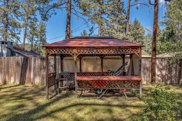 a view of a house with backyard sitting area and porch