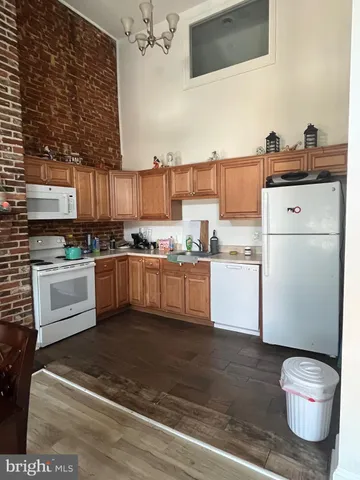 a kitchen with stainless steel appliances granite countertop a refrigerator sink and cabinets