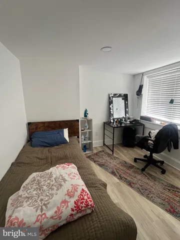 a bedroom with bed and window