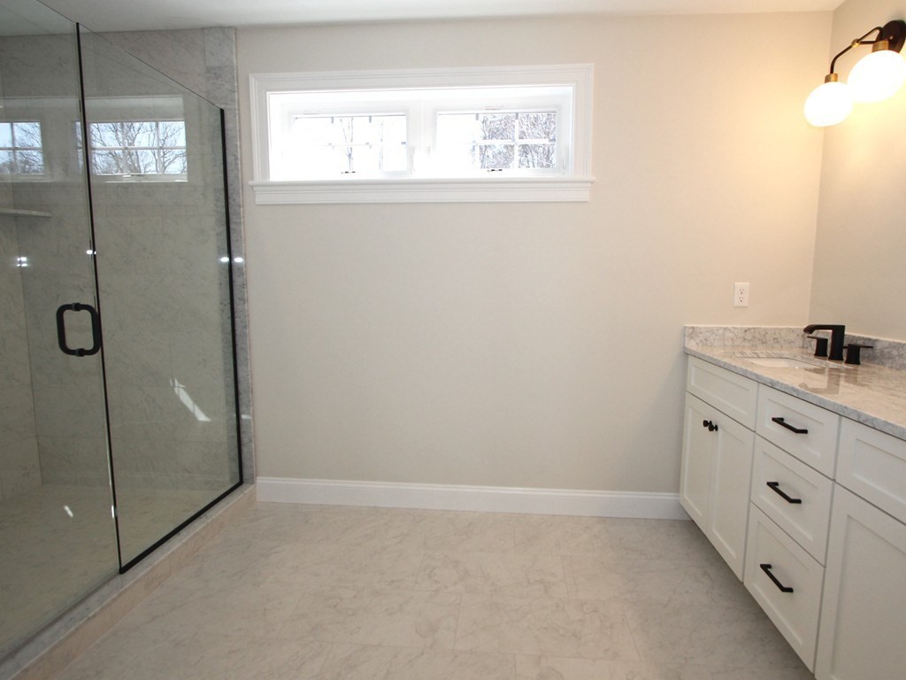 135 South S Road Holden, MA 01520 - Photo 18 of 25 a bathroom with a granite countertop sink a mirror and a shower