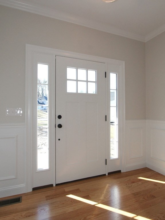 135 South S Road Holden, MA 01520 - Photo 6 of 25 a view of an empty room with window and wooden floor