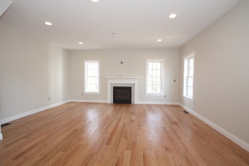 135 South S Road Holden, MA 01520 - Photo 7 of 25 an empty room with wooden floor and a window