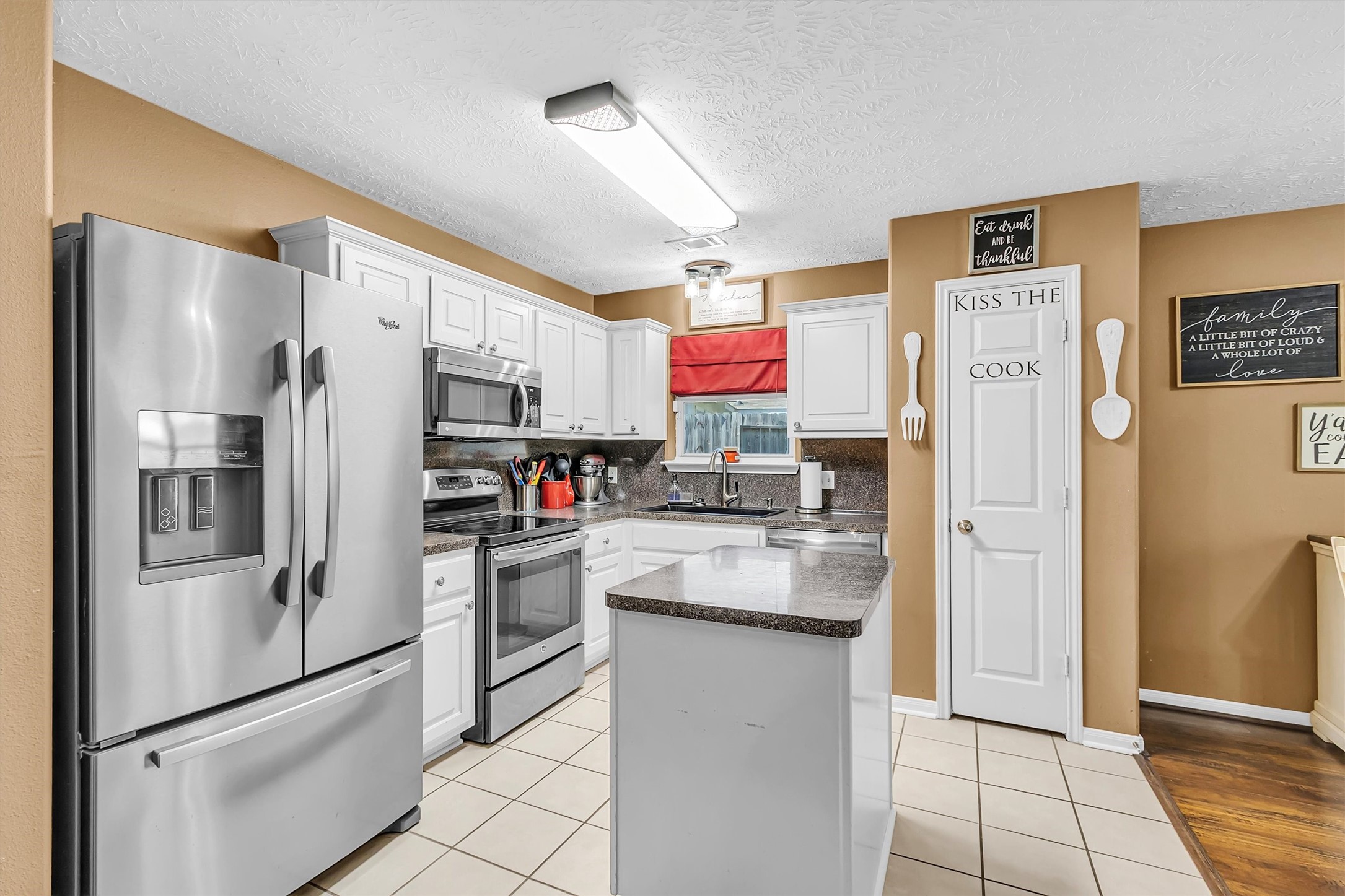4802 Comal River Loop Spring, TX 77386 - Photo 5 of 20 Tiled kitchen with an island adding some additional work space. Stainless steel appliances & pantry.