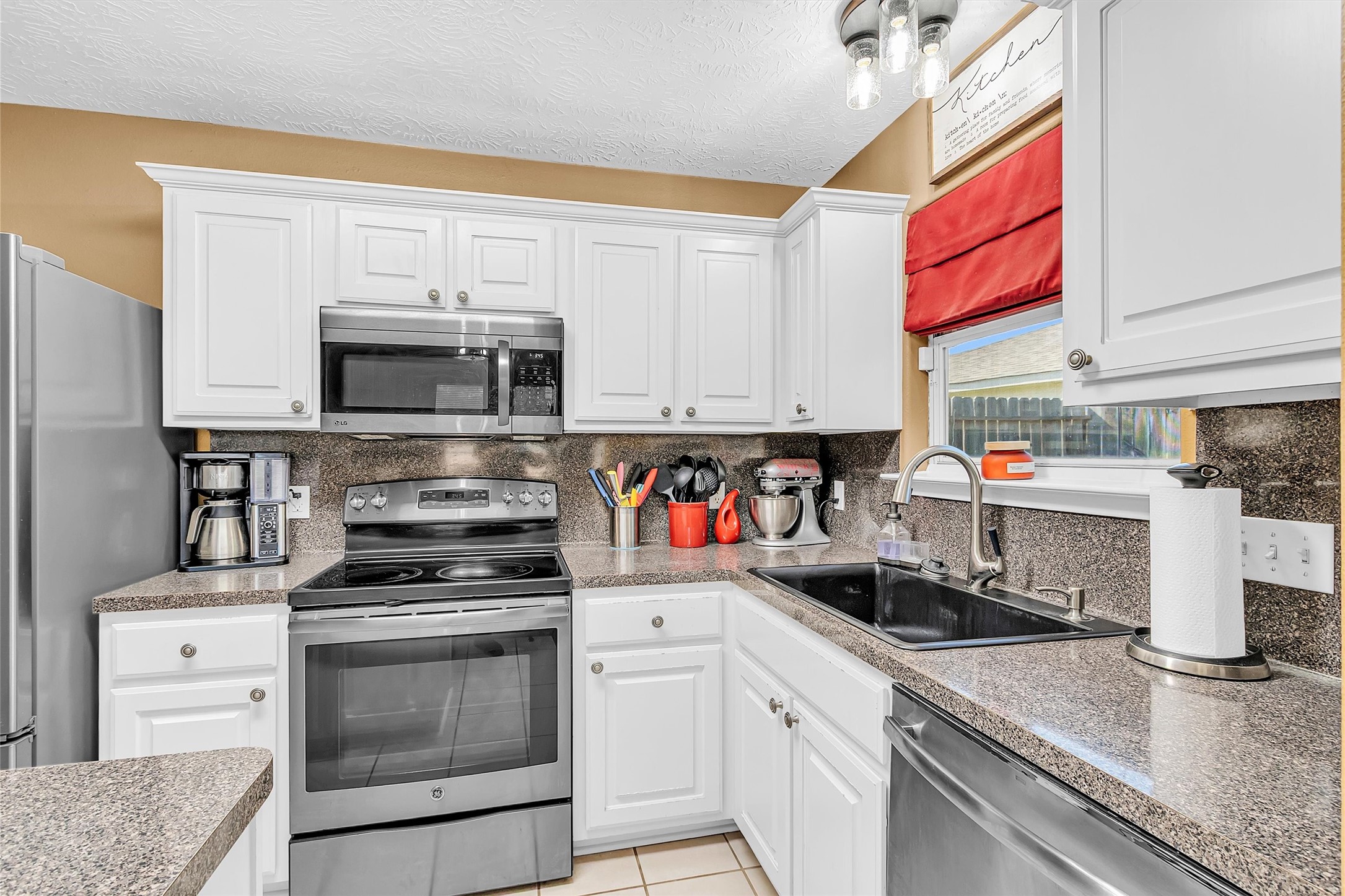 4802 Comal River Loop Spring, TX 77386 - Photo 6 of 20 L-shaped kitchen with upgraded granite sink with an overlooking window to let in natural light.