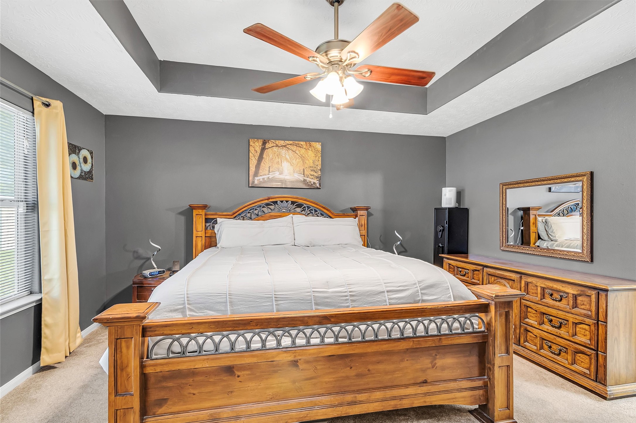 4802 Comal River Loop Spring, TX 77386 - Photo 9 of 20 Primary bedroom with large window overlooking backyard. Pretty tray ceiling for the decorative touch.