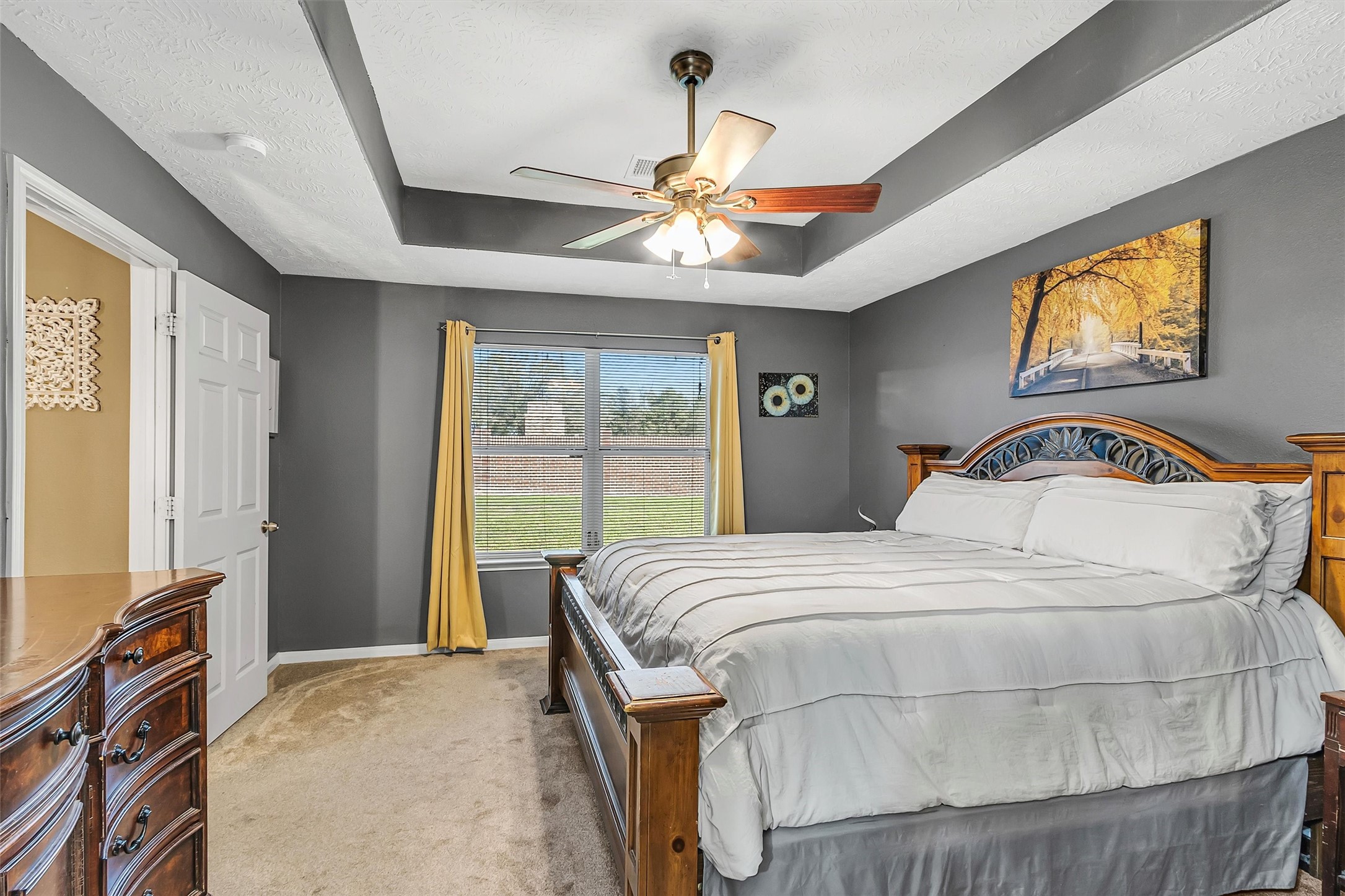 4802 Comal River Loop Spring, TX 77386 - Photo 10 of 20 Another view of the primary bedroom that overloocks the backyard. Ceiling fan for a nice breeze during our summer months.