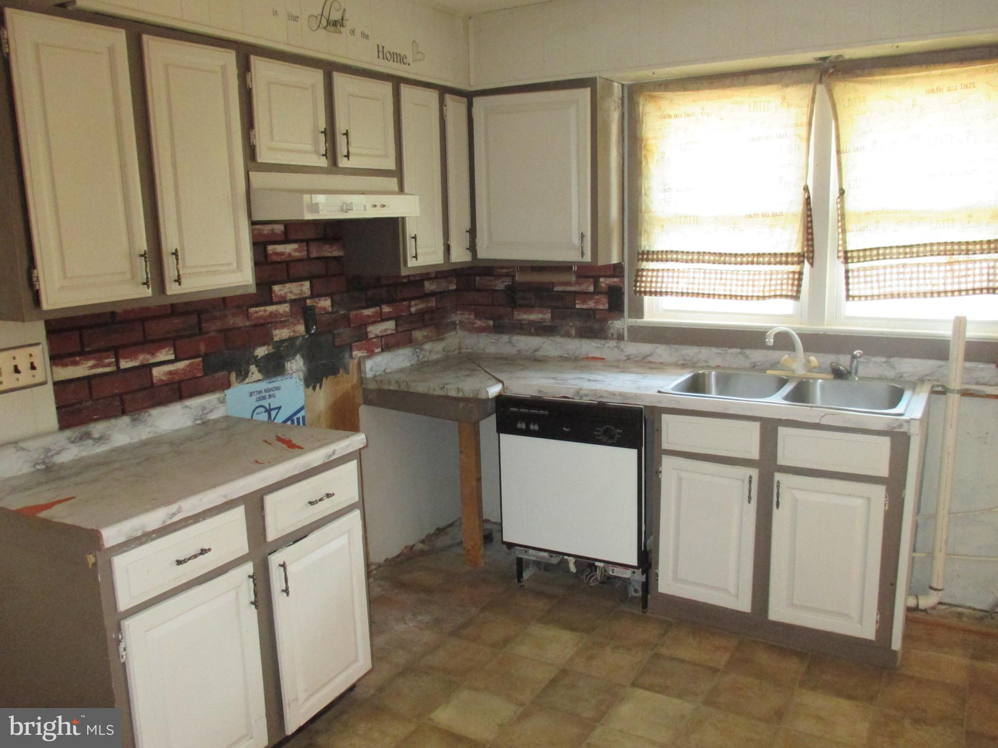 11198 Knobley Road Keyser, WV 26726 - Photo 12 of 24 a kitchen with cabinets appliances a sink and a window