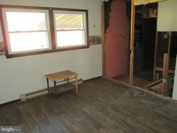 a room with wooden floor and a window