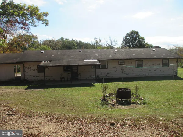 a view of a couches in backyard of house