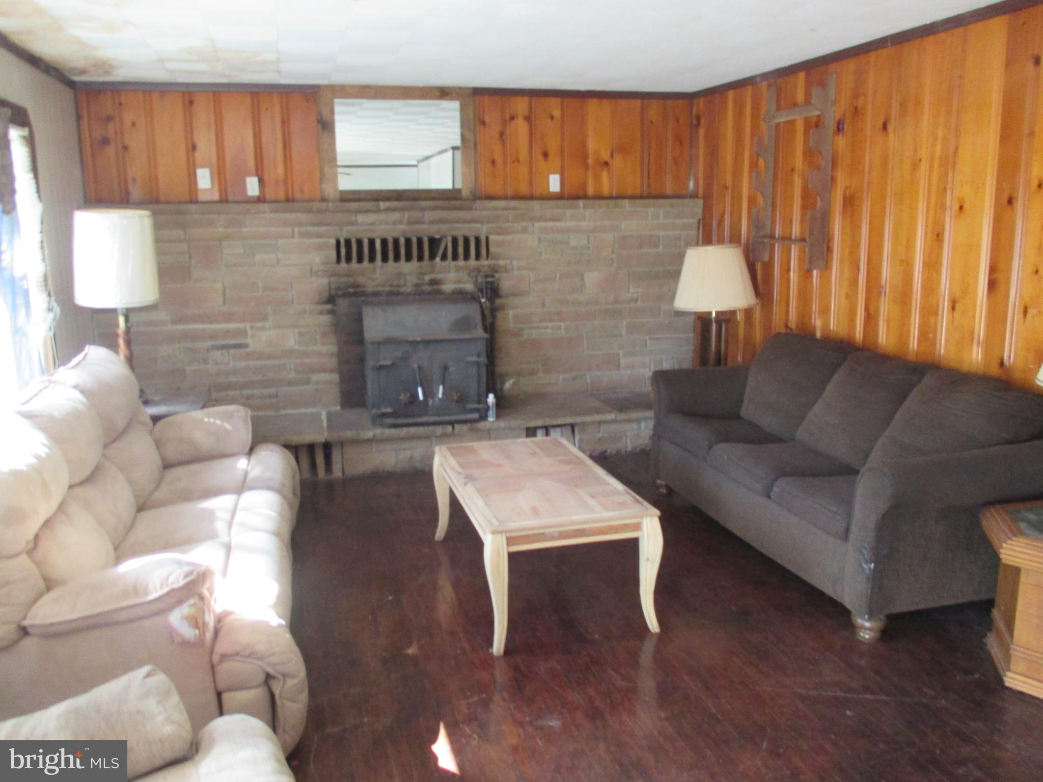 11198 Knobley Road Keyser, WV 26726 - Photo 10 of 24 a living room with furniture and a fireplace