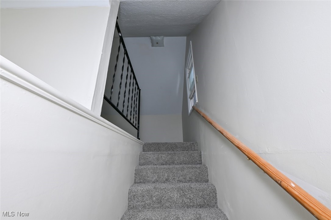 897 Reed Avenue Akron, OH 44306 - Photo 24 of 33 Stairway with a textured ceiling and carpet